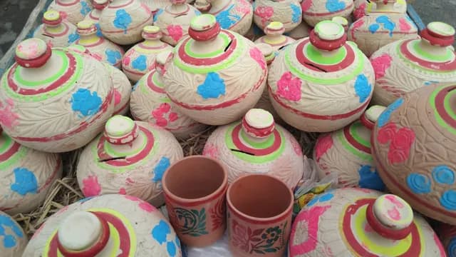 Hand-painted clay pots with lids in bright colours