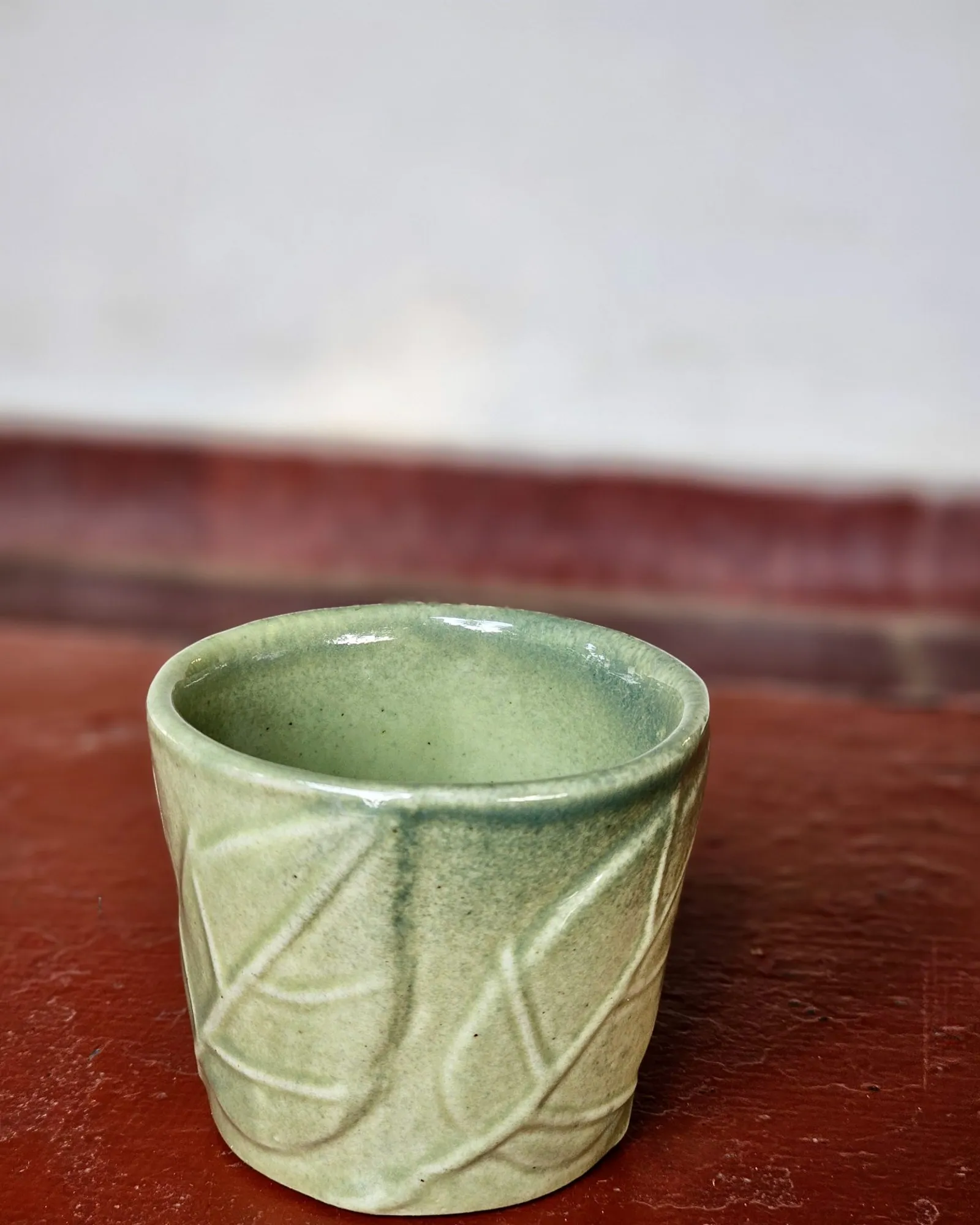 Green glazed ceramic cup
