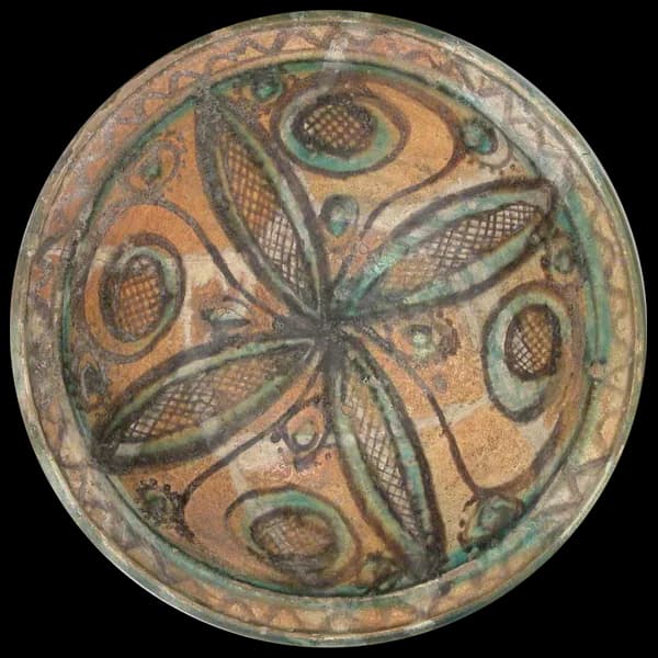 Earthenware bowl painted with a green and brown leaf pattern
