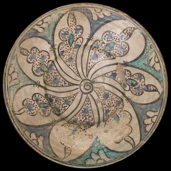 Earthenware bowl painted with a swirling floral pattern