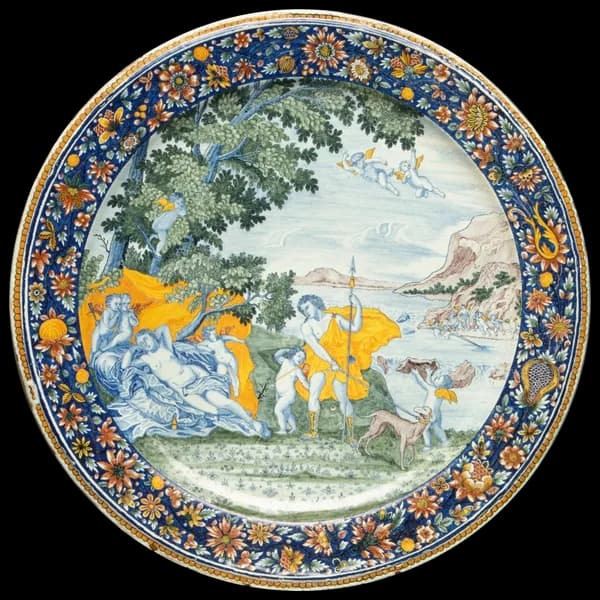 Maiolica plate painted with a landscape scene in blue and yellow