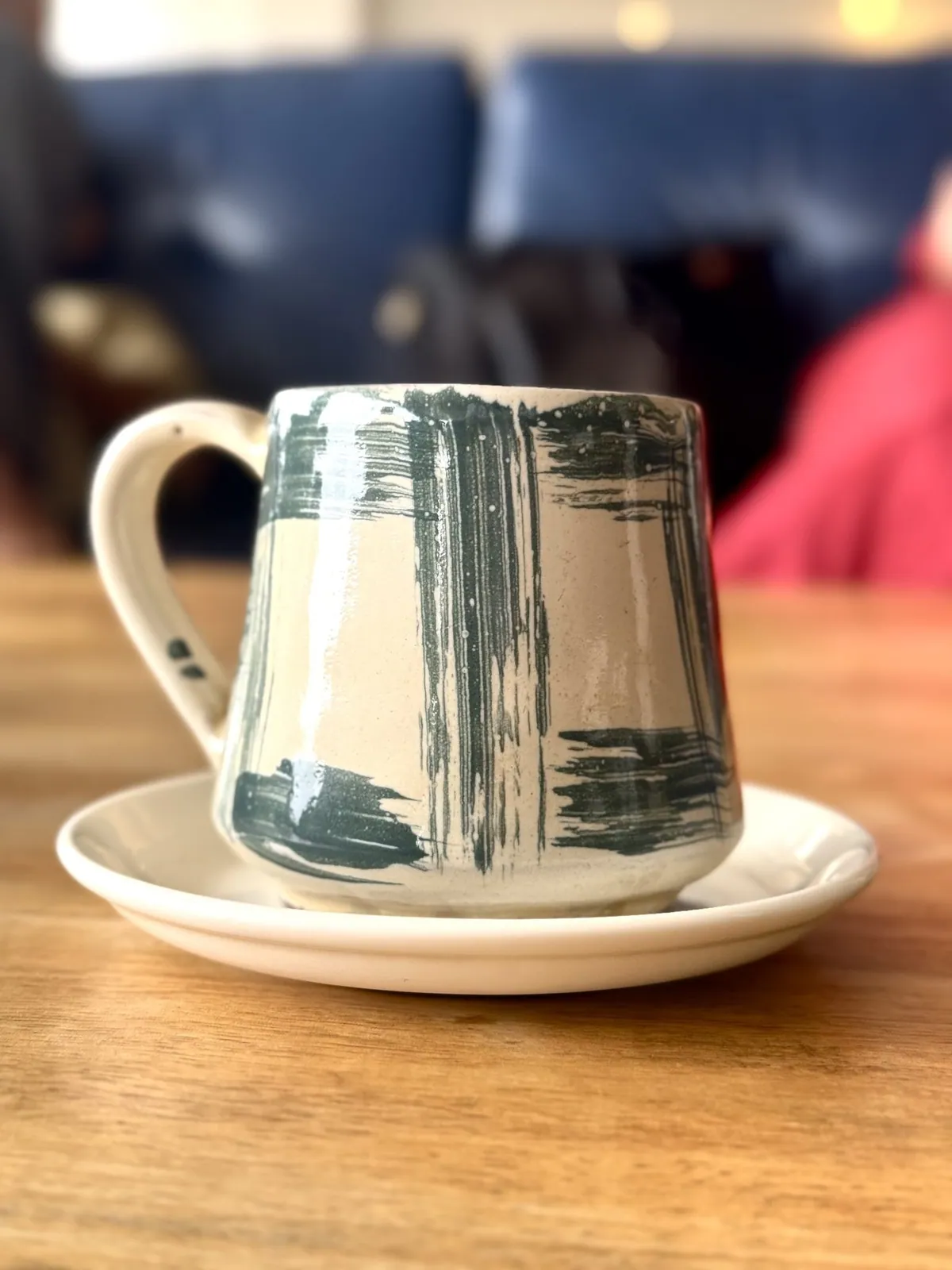 Hand-painted ceramic cup on a saucer